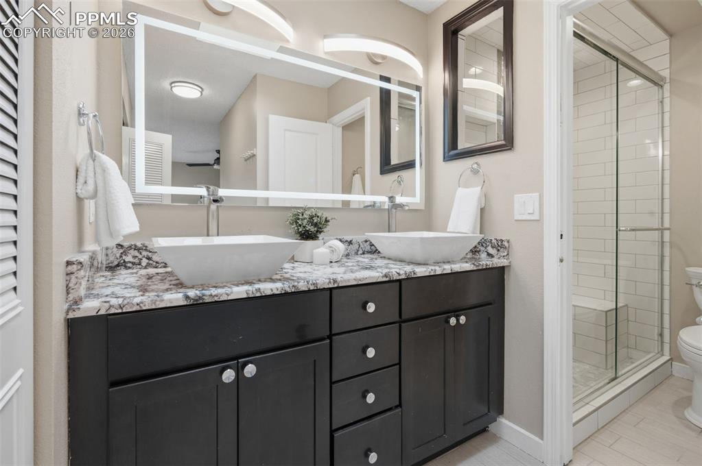 Image 34 of 50: Primary bathroom vanity and shower