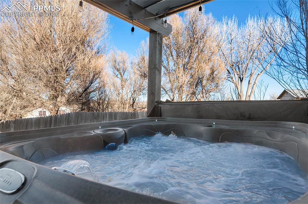 Image 42 of 50: Hot tub off the lower family room under pergola