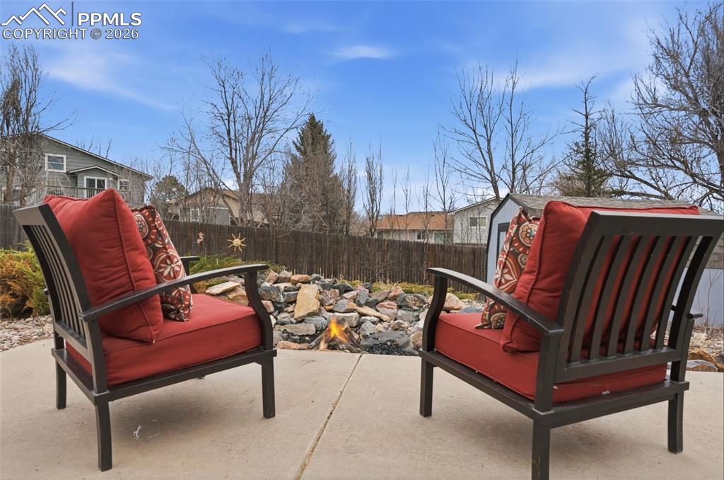 Image 50 of 50: Fenced backyard featuring a patio and firepit
