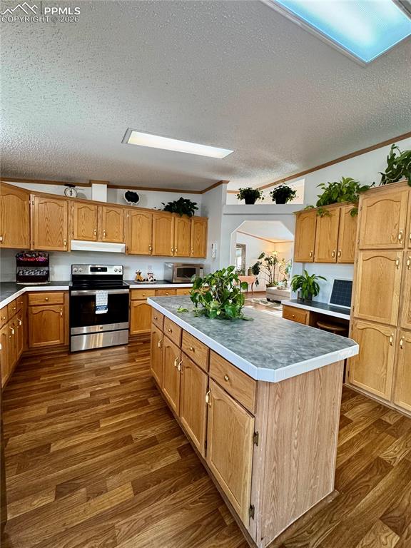 Image 13 of 44: Kitchen with a kitchen island, stainless steel appliances, crown molding, l