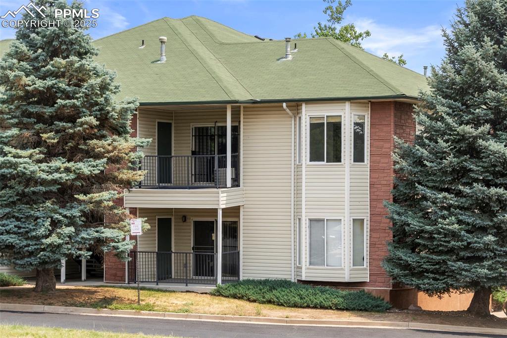 Caption: View of front of home featuring a balcony, a porch, and a shingled roof