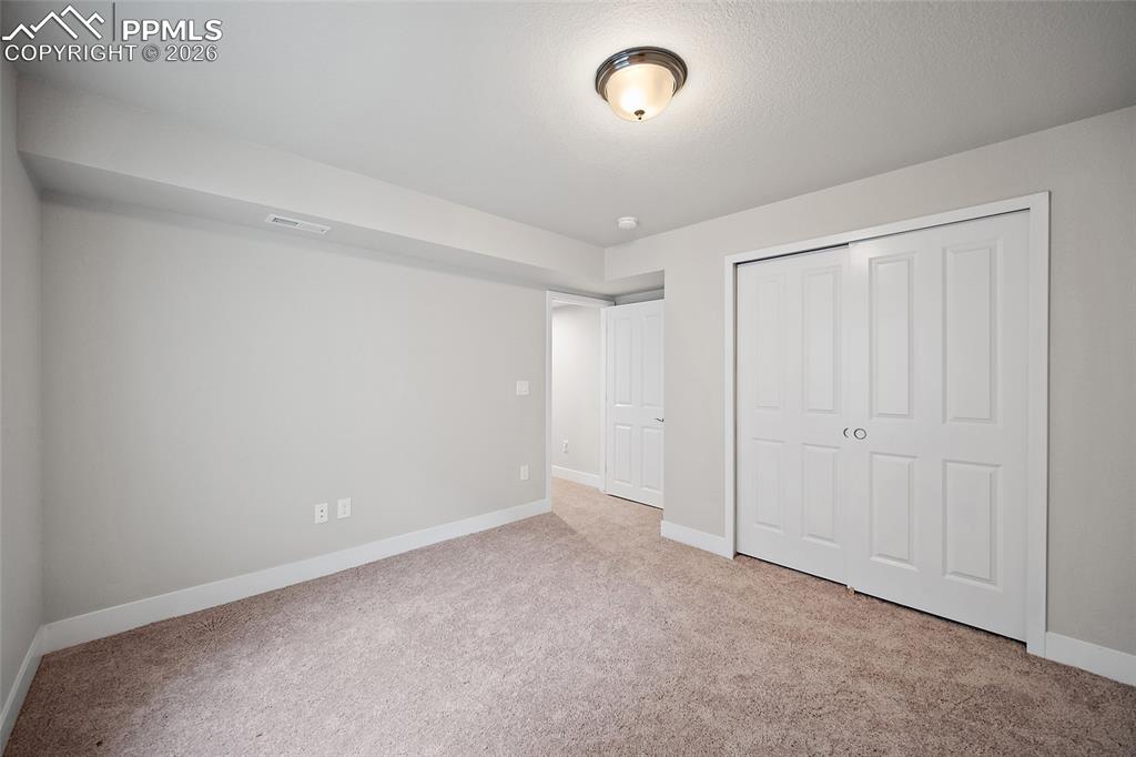 Image 37 of 49: Basement bedroom