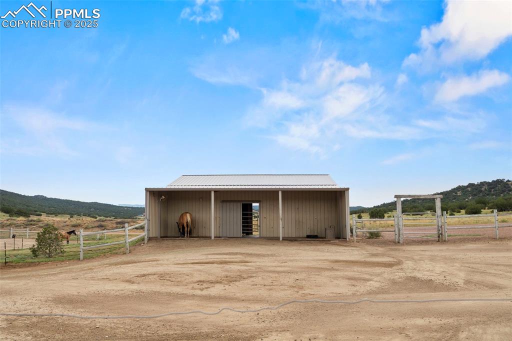 Image 14 of 41: View of outbuilding featuring a view of countryside, an exterior structure,