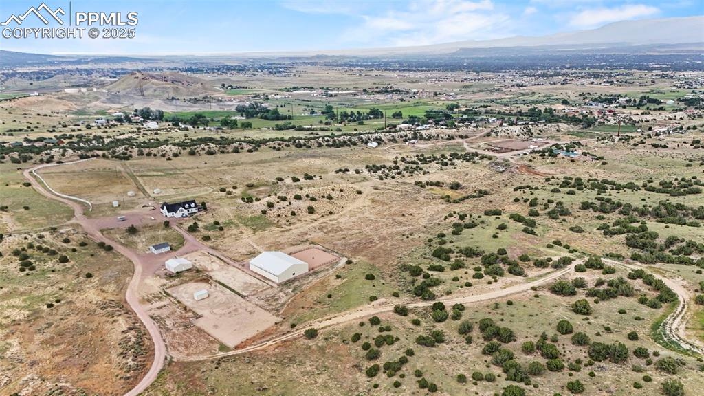 Image 2 of 41: Aerial view of property and surrounding area with a mountainous background