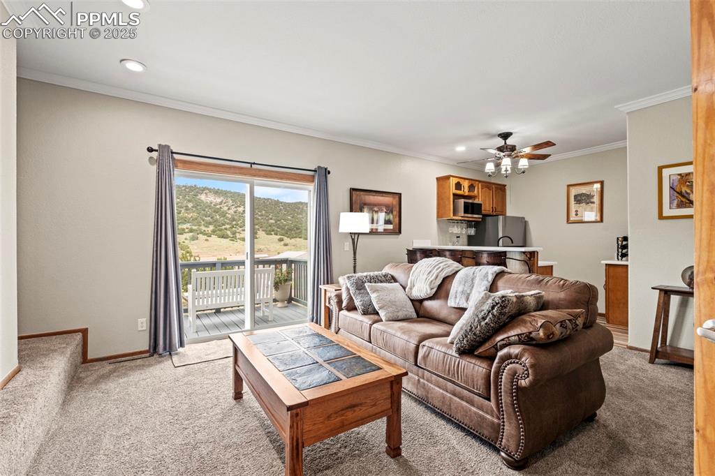 Image 23 of 41: Living room featuring light carpet, recessed lighting, a ceiling fan, and o