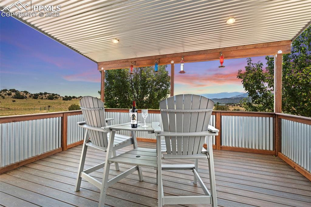 Image 30 of 41: Deck at dusk featuring outdoor dining area