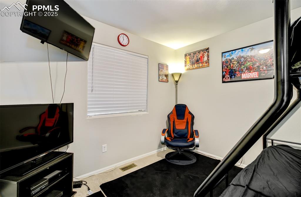 Image 15 of 35: Exercise area featuring light colored carpet and baseboards