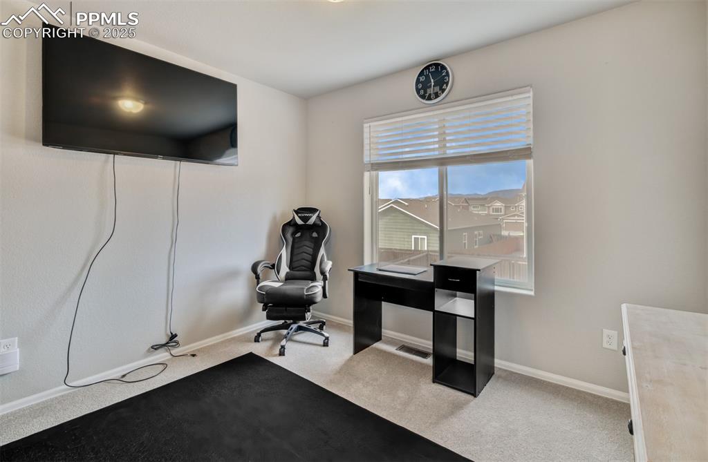 Image 17 of 35: Office space featuring light colored carpet and baseboards