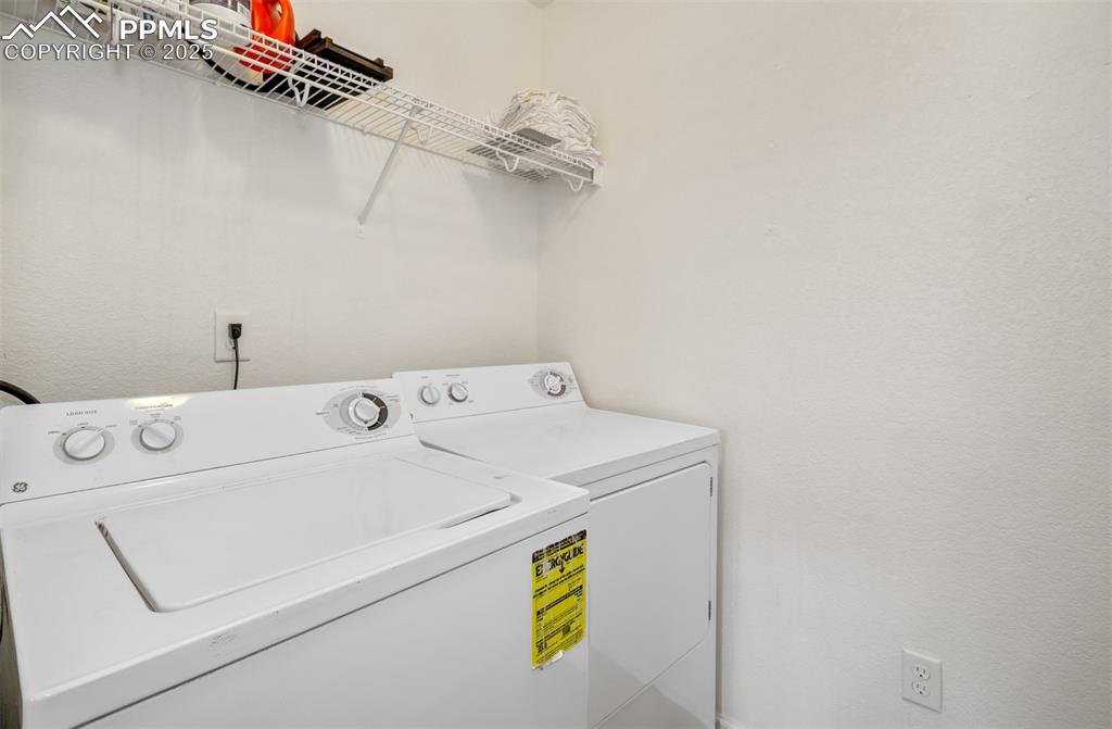 Image 22 of 35: Washroom featuring washing machine and dryer
