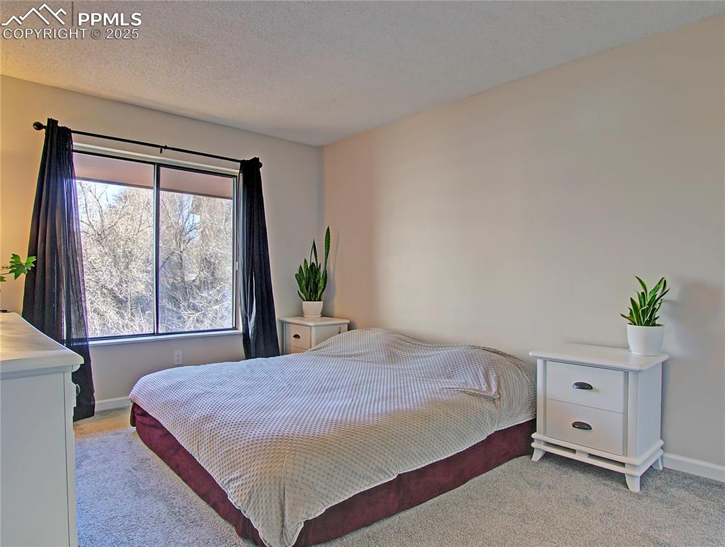 Image 15 of 30: Master bedroom with large window.