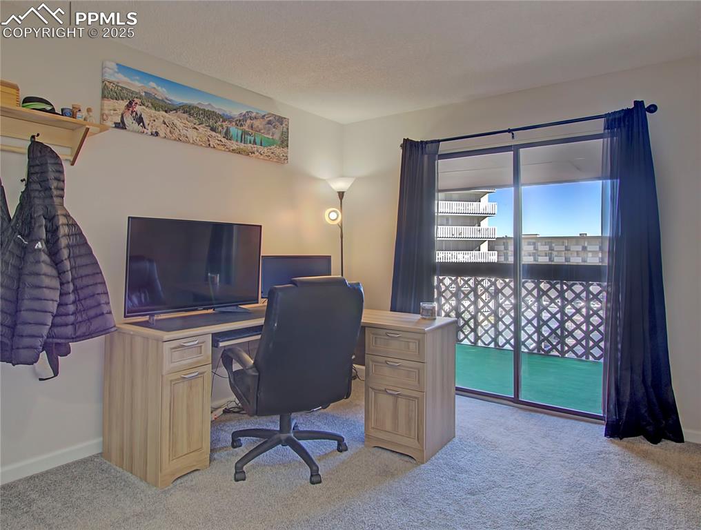 Image 17 of 30: Second bedroom currently set up at an office