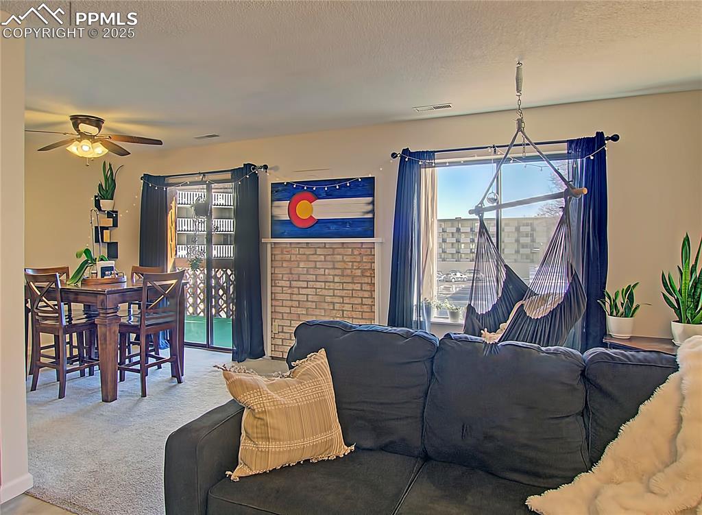 Image 2 of 30: Dining/Living room walks out to covered deck. Swing provides extra seating