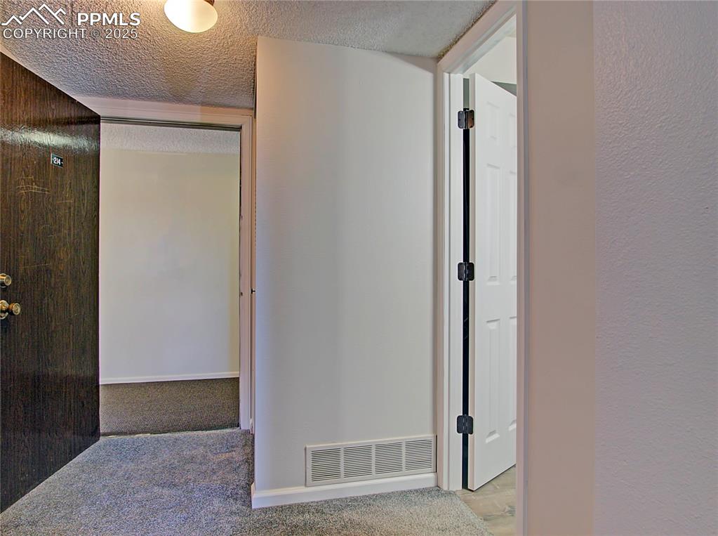 Image 22 of 30: Upstairs hallway with furnace closet and secondary access