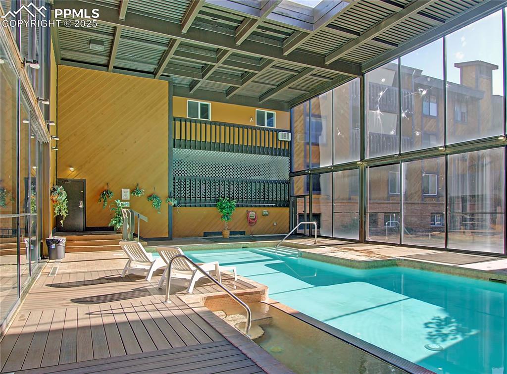 Image 27 of 30: Indoor pool with hot tub