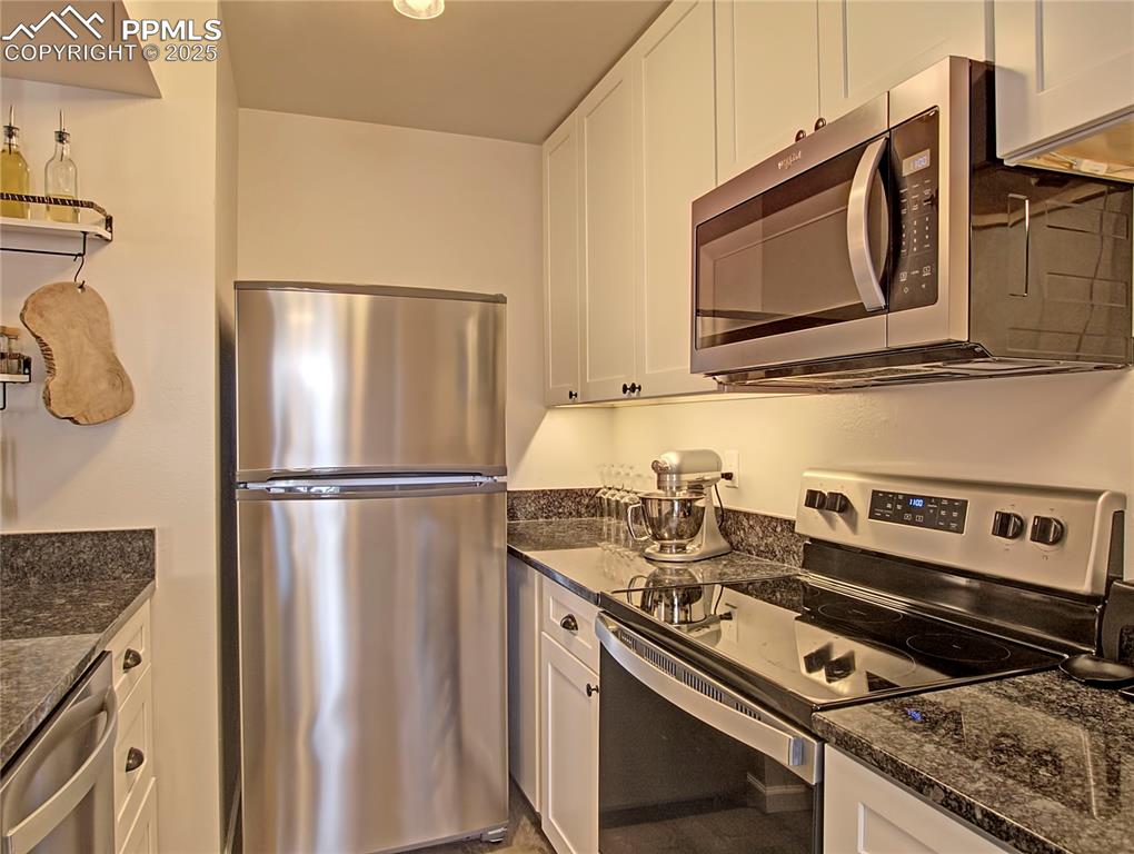Image 7 of 30: Kitchen has been fully remodeled with stainless steel appliances, spacious 