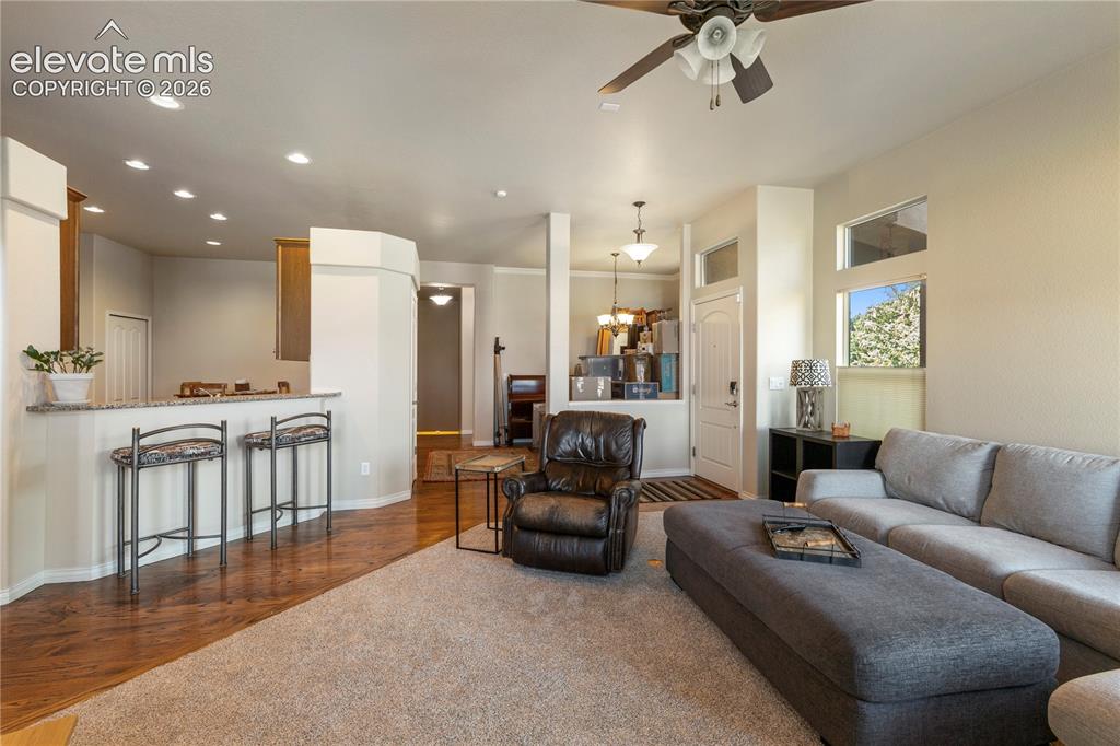 Image 6 of 31: Living room opens to the kitchen