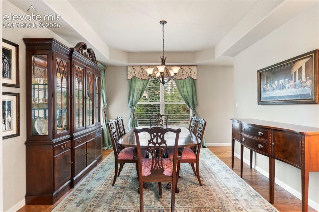 Image 10 of 50: Formal dining area with trayed ceiling