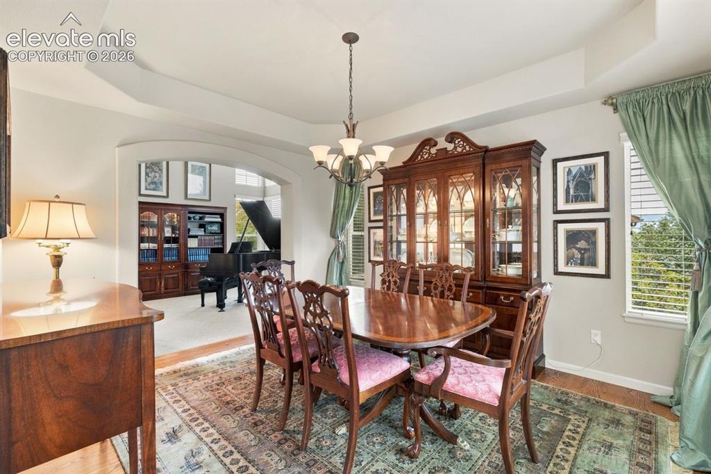 Image 11 of 50: Formal dining area with trayed ceiling