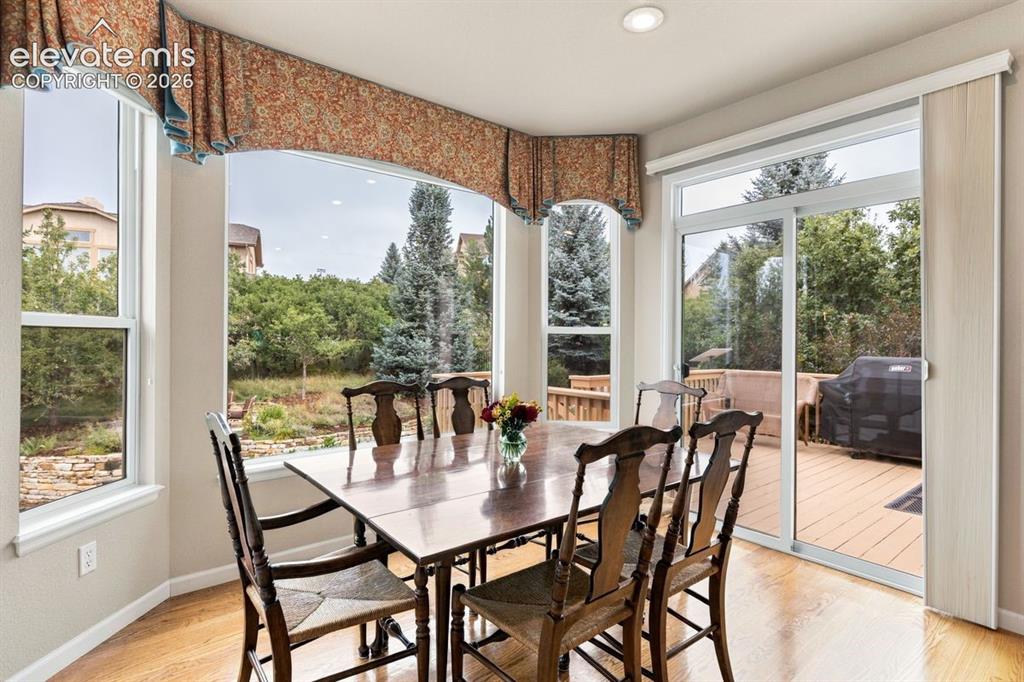 Image 12 of 50: Dining nook with large bay window and walk out access