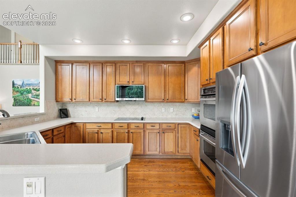 Image 13 of 50: Gourmet kitchen with double ovens, newer microwave, new fridge
