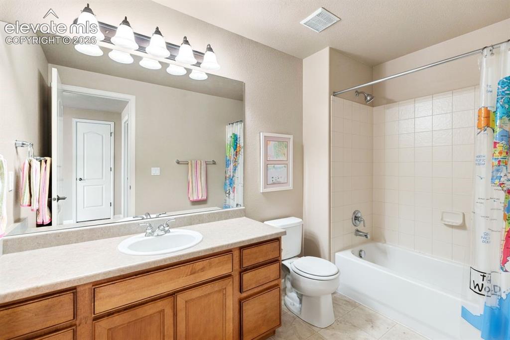 Image 25 of 50: Full bathroom with tub shower and single sink vanity