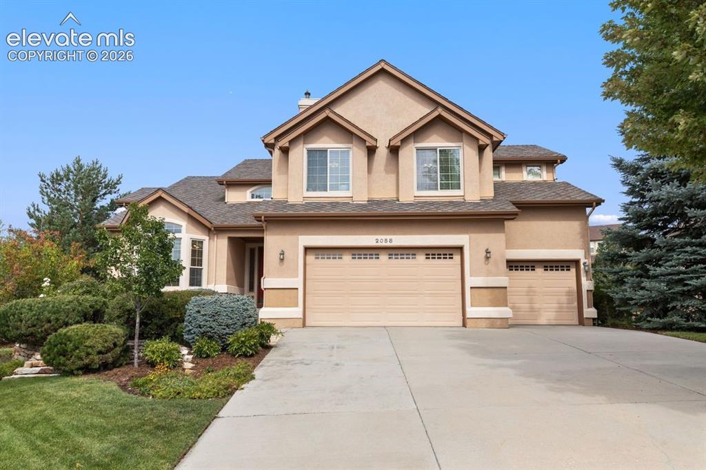 Image 41 of 50: Front of home with mature landscaping