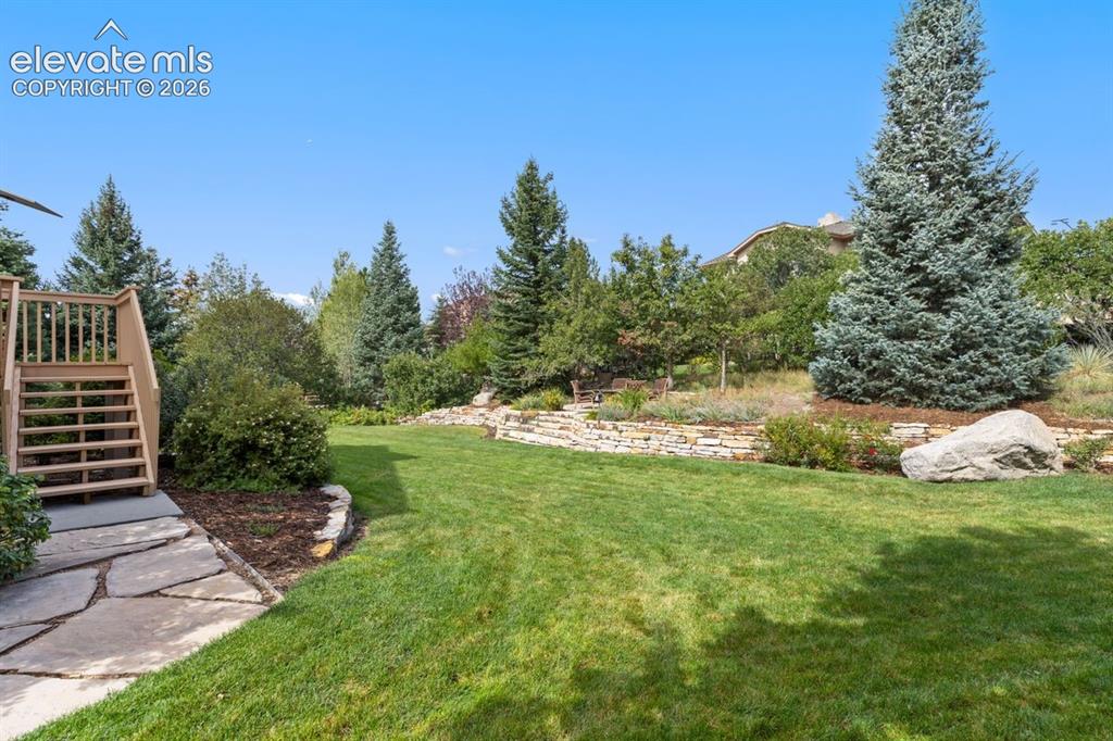 Image 45 of 50: Beautifully landscaped backyard