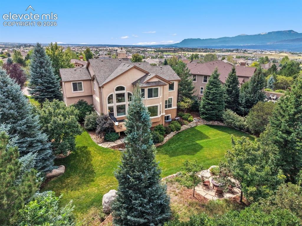 Image 5 of 50: Backyard with mature landscaping