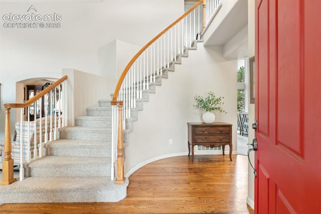 Image 6 of 50: Entry with grand foyer and stunning curved staircase 