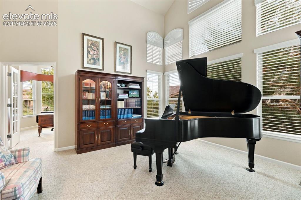 Image 8 of 50: Formal living room with wall of windows