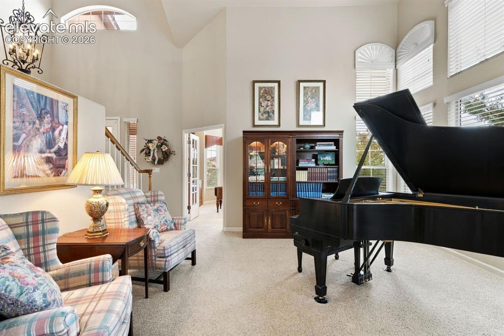 Image 9 of 50: Formal living room with wall of windows