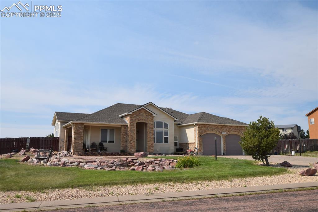 Caption: Single story home with an attached garage, a shingled roof, and concrete driveway