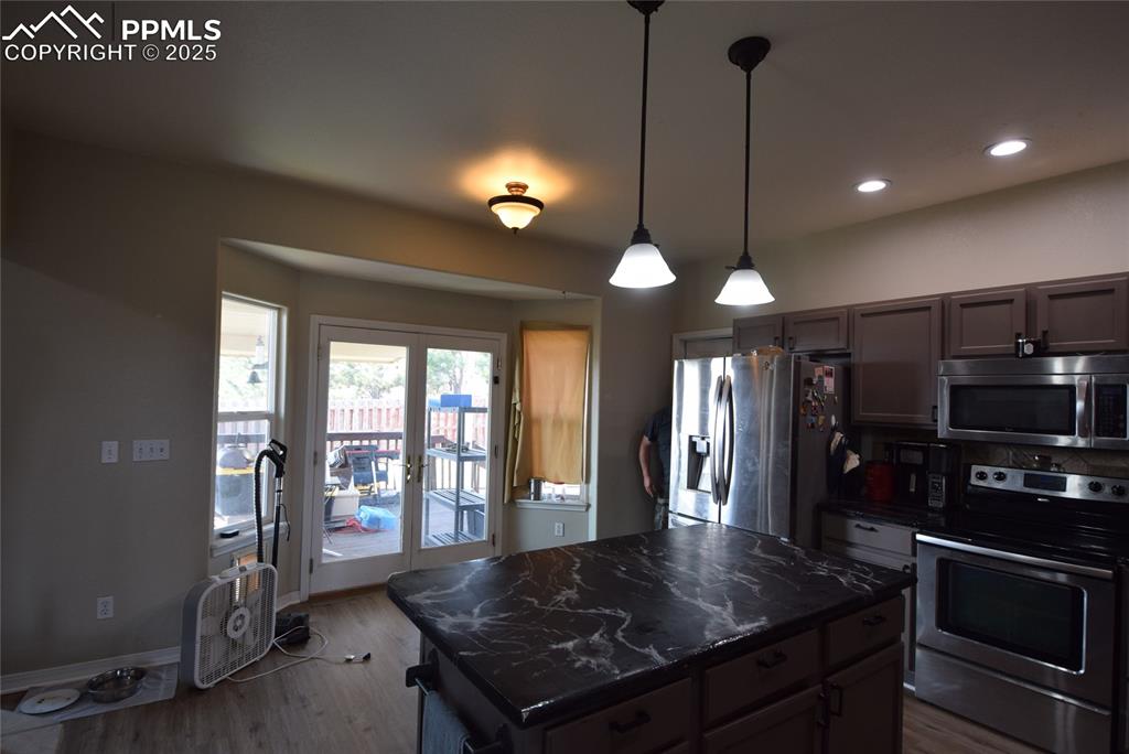 Image 16 of 50: Kitchen featuring stainless steel appliances, wood finished floors, recesse