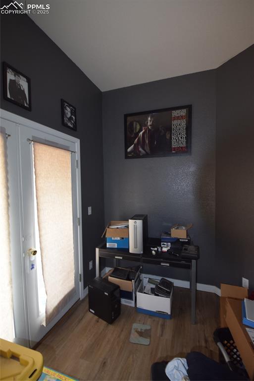 Image 19 of 50: Office area featuring wood finished floors and baseboards