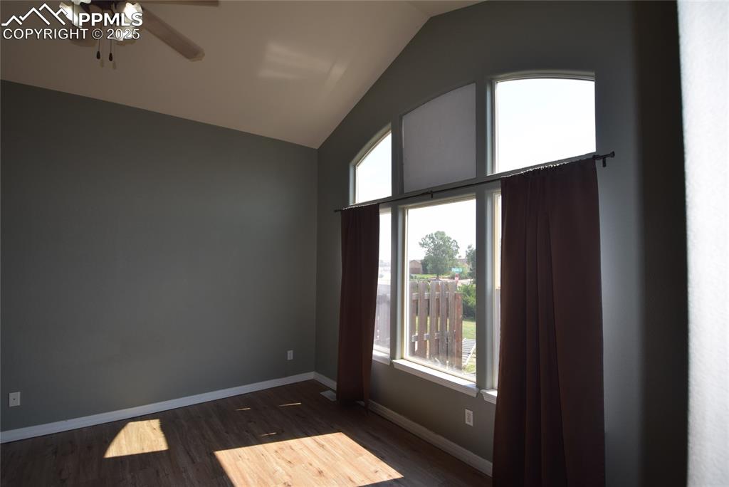 Image 33 of 50: Spare room featuring lofted ceiling, dark wood-type flooring, and a ceiling