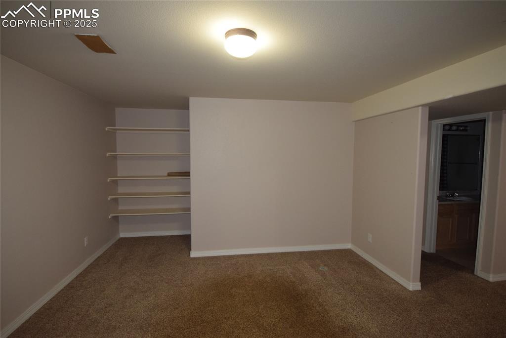 Image 40 of 50: Unfurnished bedroom featuring carpet and baseboards