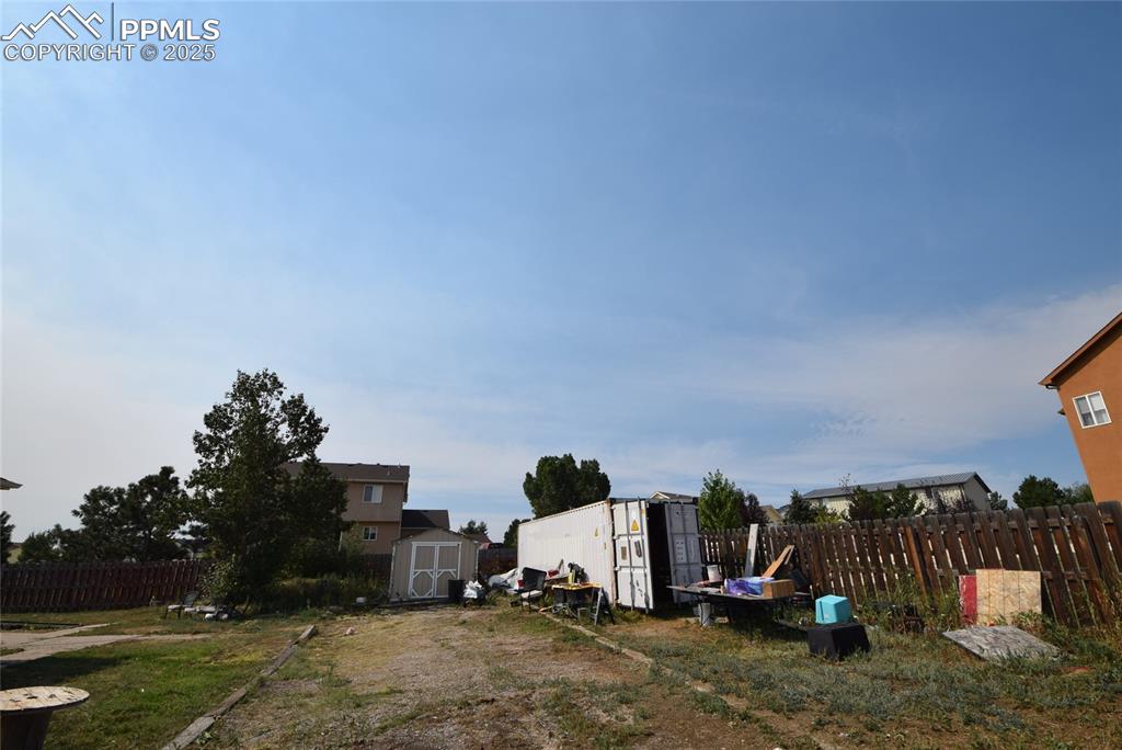 Image 45 of 50: View of yard featuring a storage unit