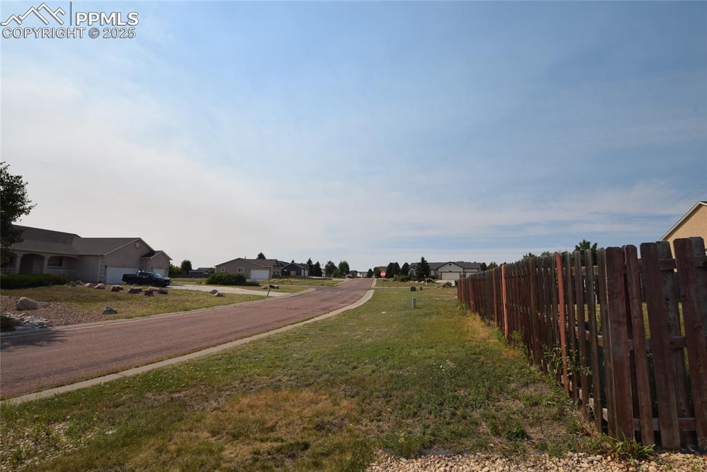 Image 49 of 50: View of asphalt street featuring a residential view