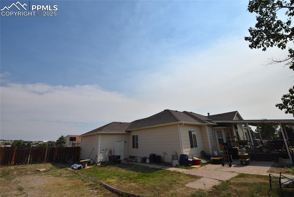Image 5 of 50: Rear view of house featuring a patio and a shingled roof