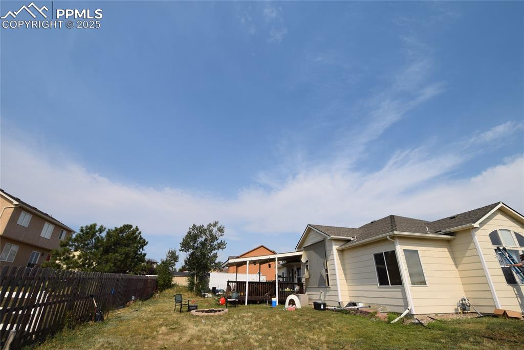 Image 50 of 50: View of property exterior featuring an outdoor fire pit and a fenced backya