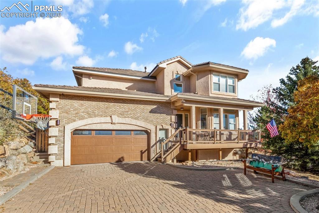Image 1 of 49: Mediterranean / spanish-style home with decorative driveway, brick siding, 