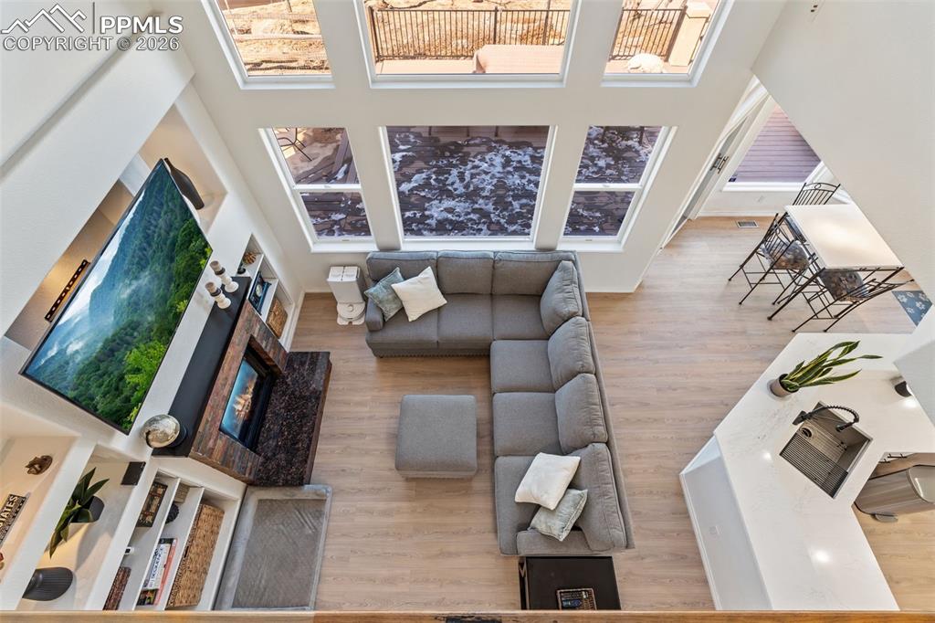 Image 22 of 49: Living area featuring a high ceiling and light wood finished floors