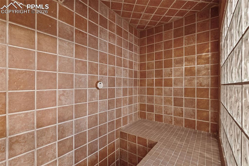 Image 40 of 49: Full bathroom with tiled shower