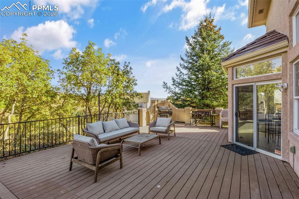 Image 42 of 49: Wooden terrace with an outdoor living space