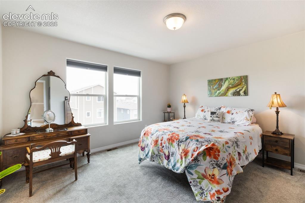 Image 13 of 28: Carpeted room featuring light-toned walls, a flush-mount ceiling light, and