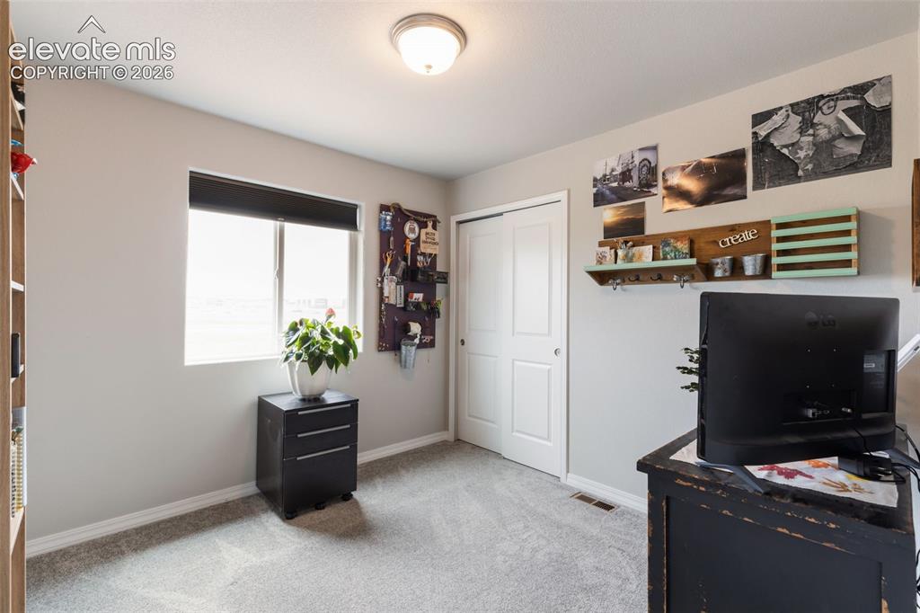 Image 20 of 28: Room featuring light gray wall paint, a window with a black roller shade, l