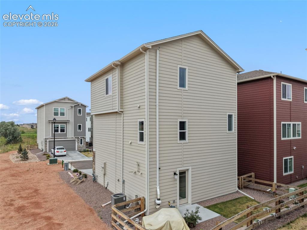 Image 25 of 28: Beige horizontal siding exterior with multiple windows