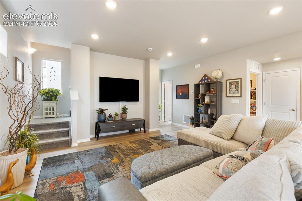 Image 7 of 28: Open-concept living space featuring recessed lighting, wood-finish flooring