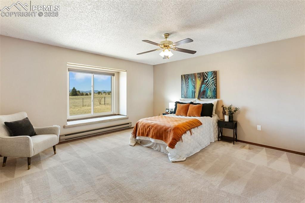 Image 30 of 50: Sunroom features easy maintenance carpet, and mountain views.