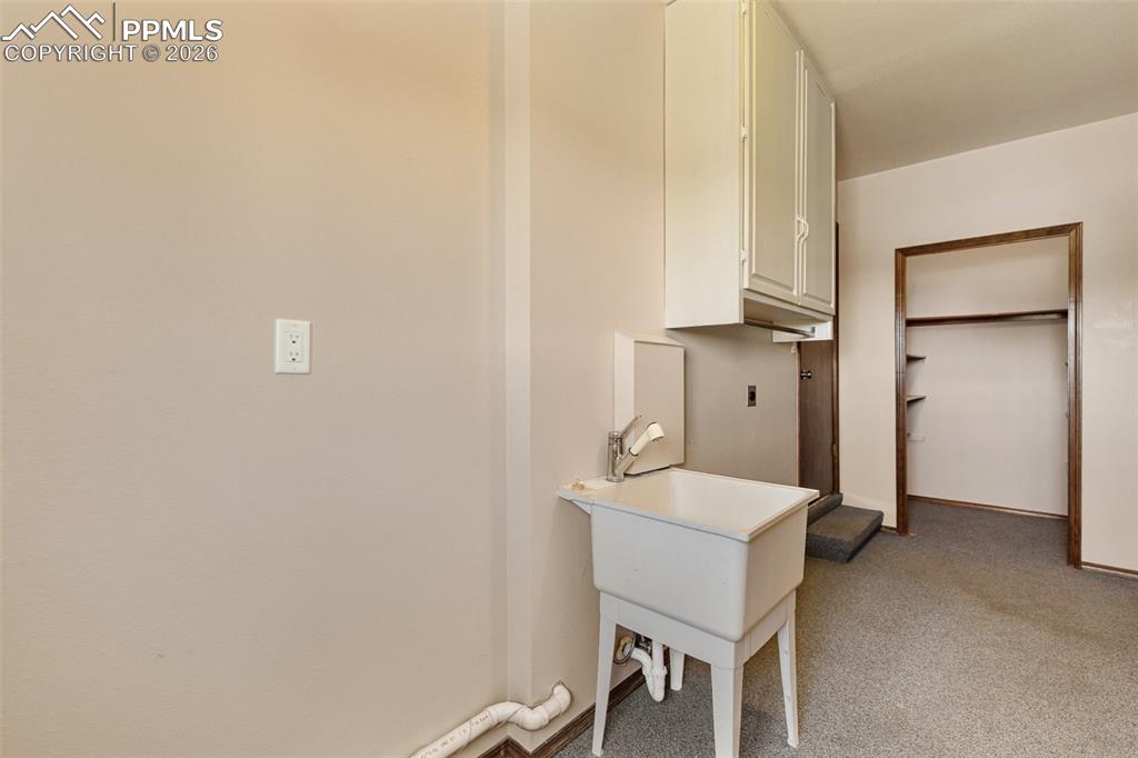 Image 45 of 50: Remodeled hall bath features solid granite countertop, custom cabinetry, he